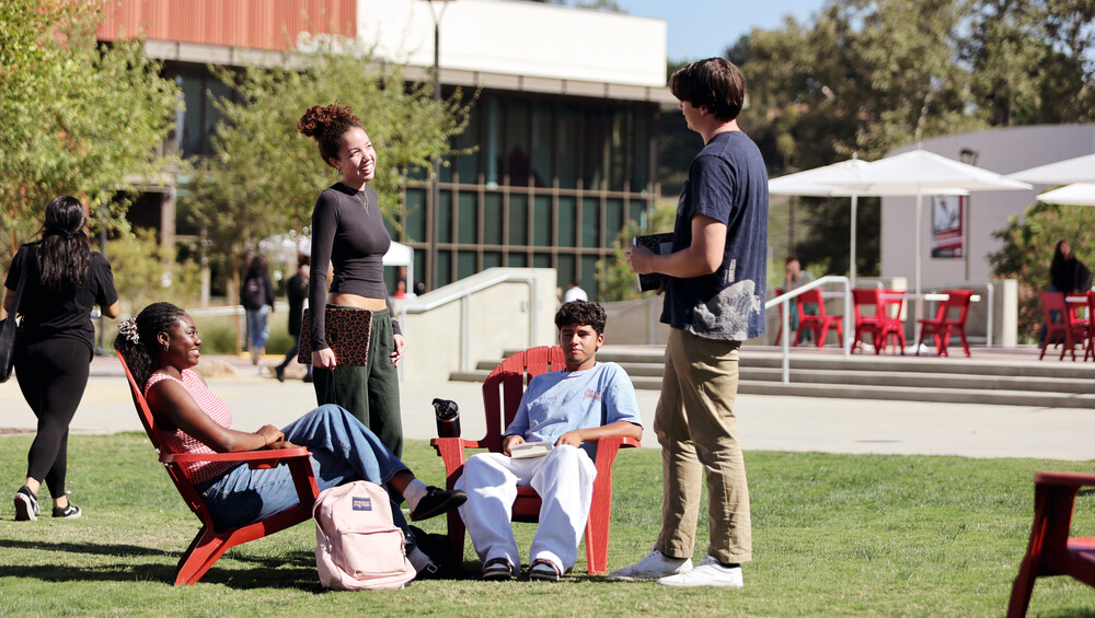 students sitting and chatting on campus