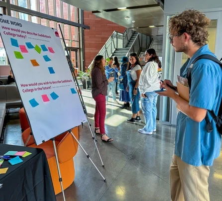 student reading board of post its thumbnail