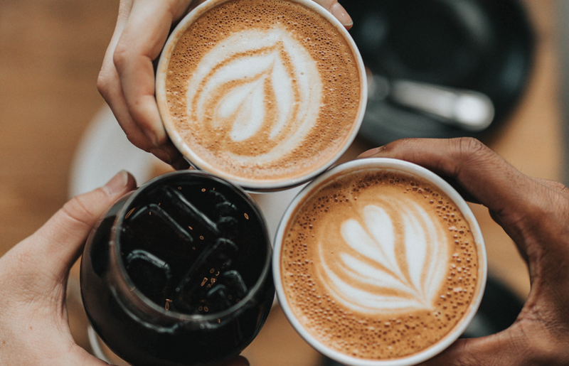 cheersing three cups of coffee