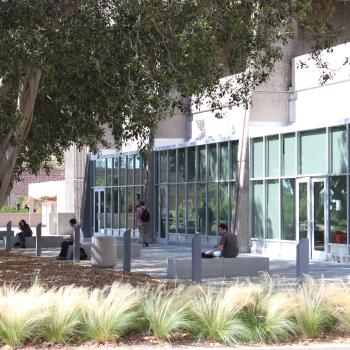 students sitting outside near building