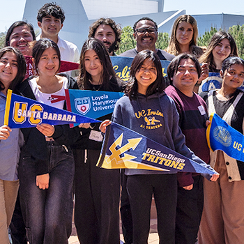 students holding college pennants