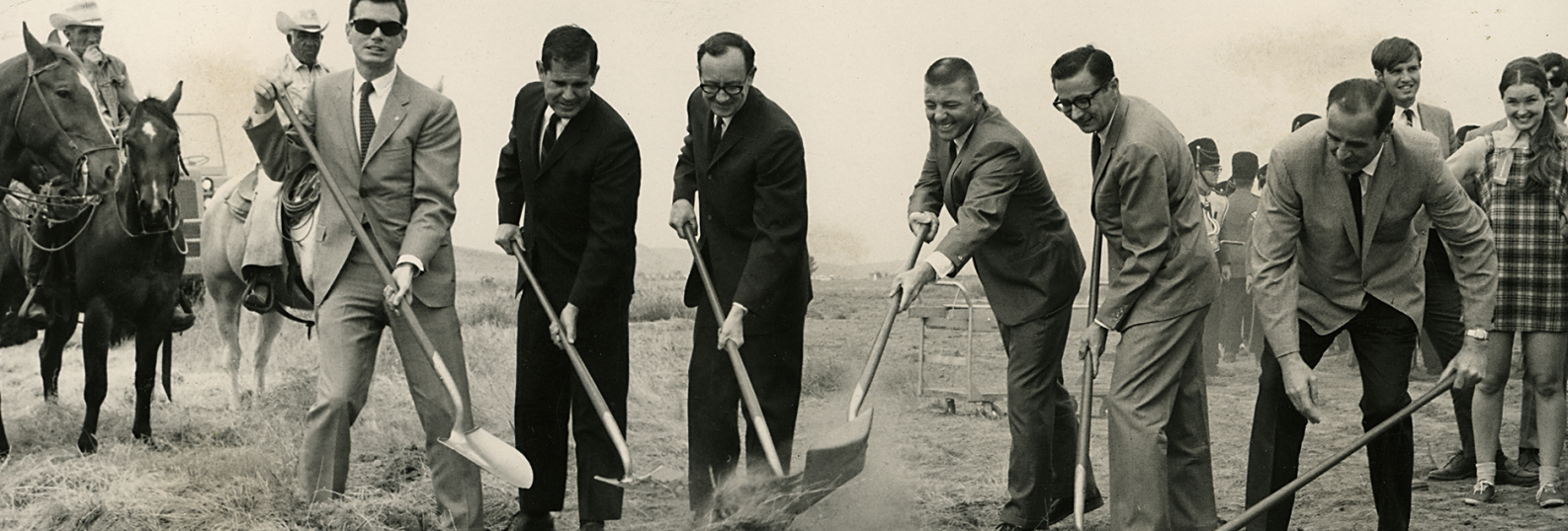 people with shovels digging