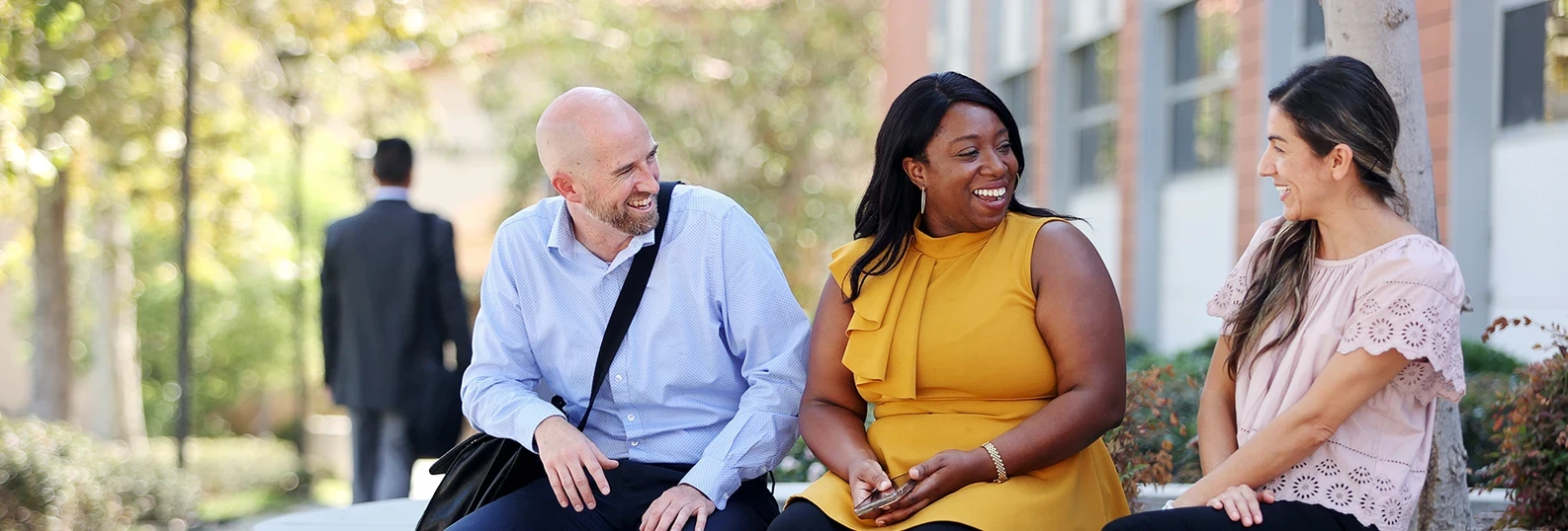 three coworkers sitting and laughing