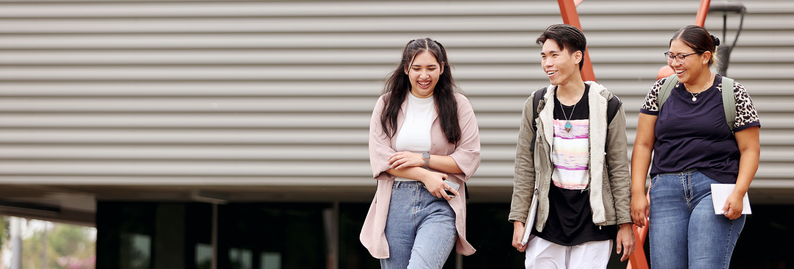 three students laughing together