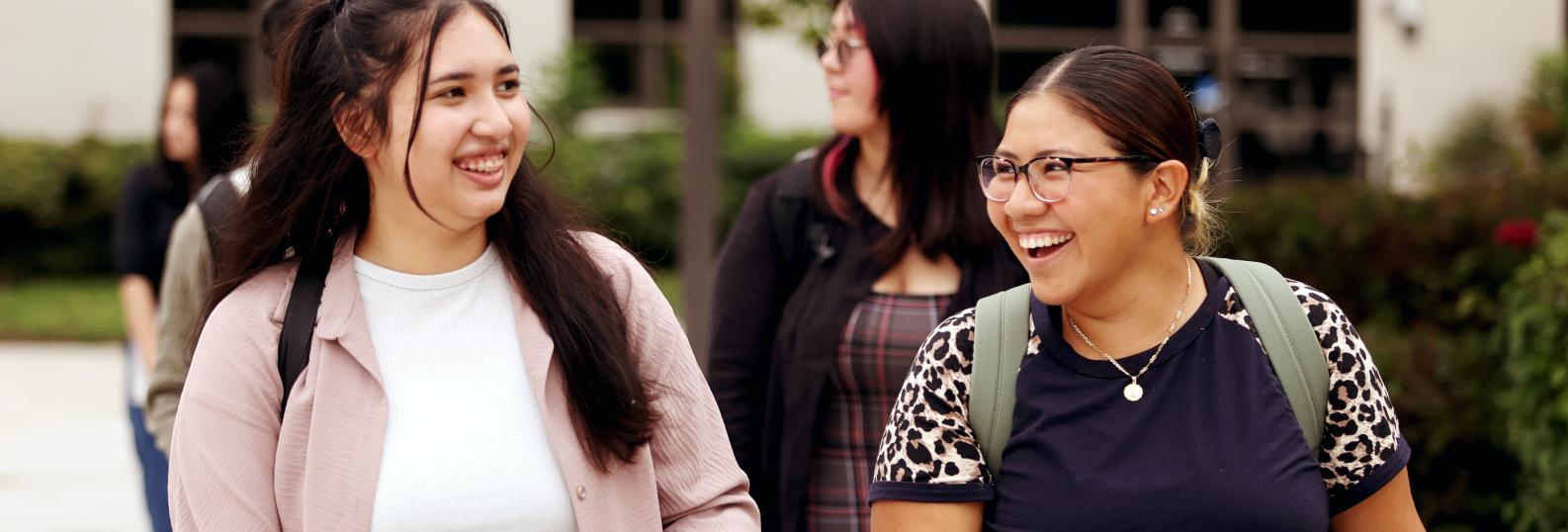 Two female college students walking