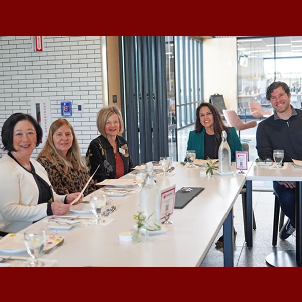trustees sitting at table waiting for food