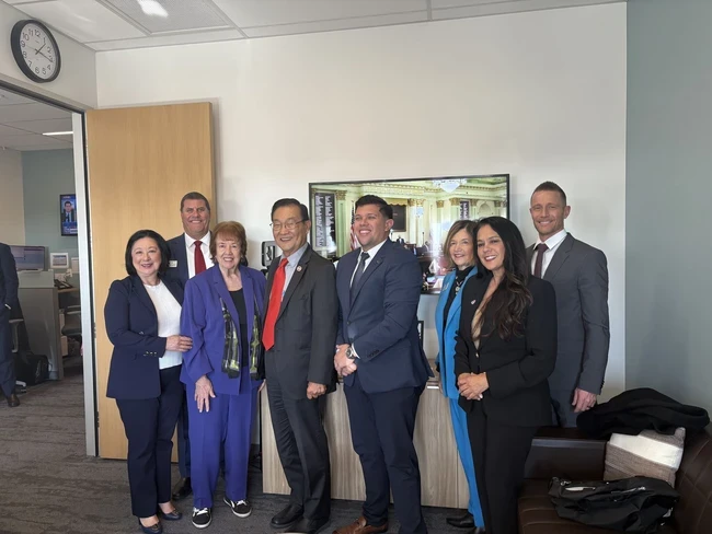 Board of Trustees pose with legislator during visits