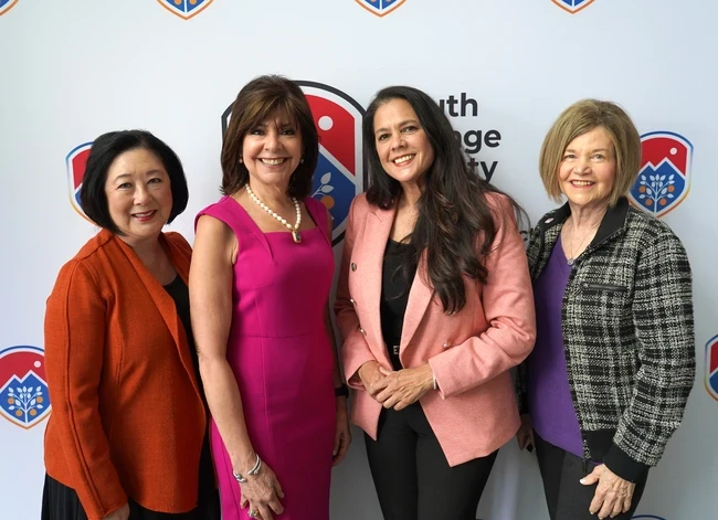 trustees bartlett and milchiker pose with chancellor barnes and the speaker of the women's history month luncheon