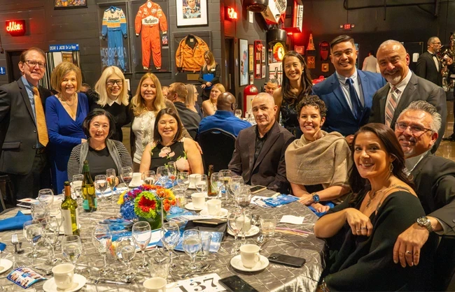 people at a table posing for a picture
