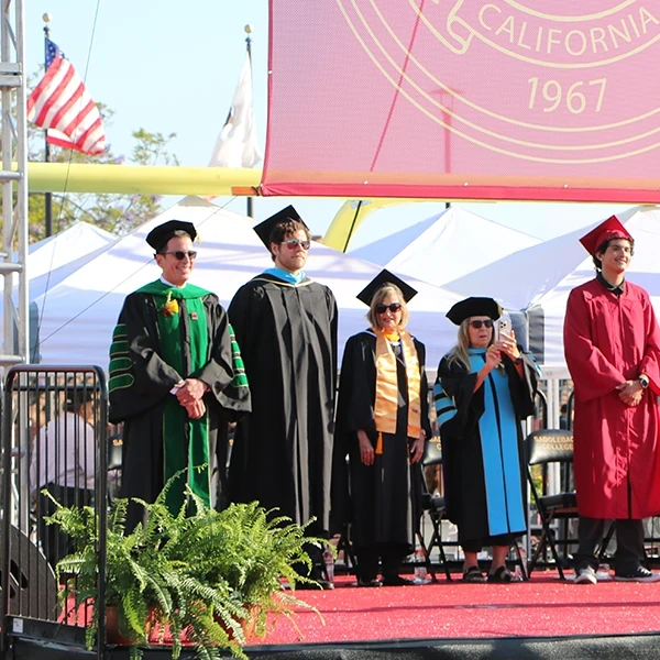 trustees on stage at commencement
