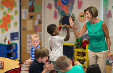 student high-fiving a teacher