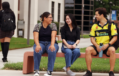 multiple students walking and sitting on campus