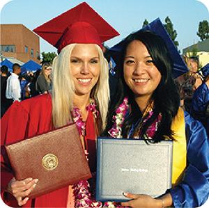 Two college graduates smiling