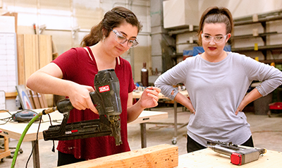 two women using power tools