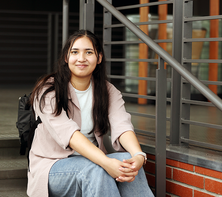 student sitting on stairs