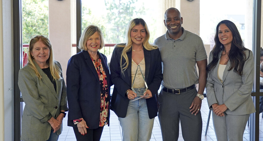 people posing with award winner